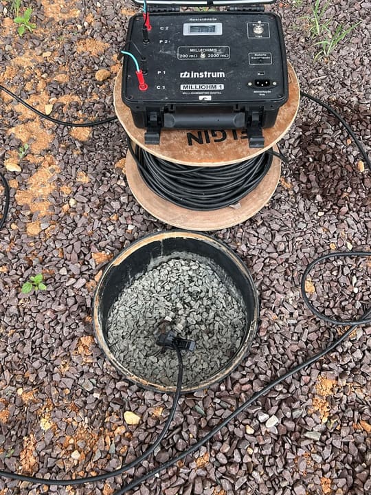 Miliohmímetro digital conectado a poço de aterramento durante ensaio de SPDA